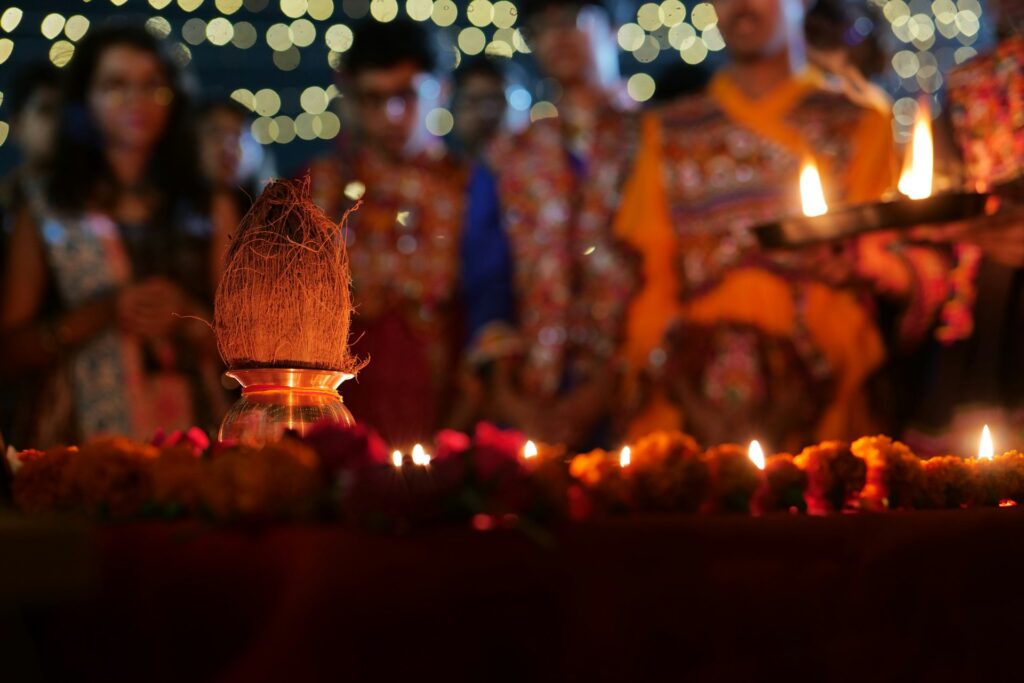 Coconut on a gold kalash with lit diyas for the Navratri aarti