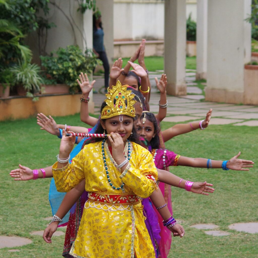 Young girls in traditional festive dress performing a dance