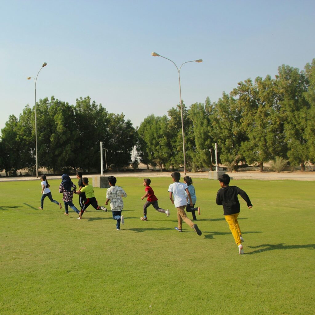 Young children playing a game of football